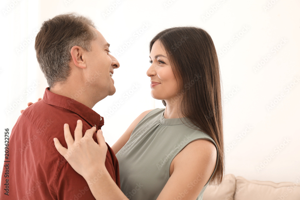 Lovely couple dancing together indoors