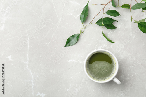 Flat lay composition with matcha tea and leaves on light background