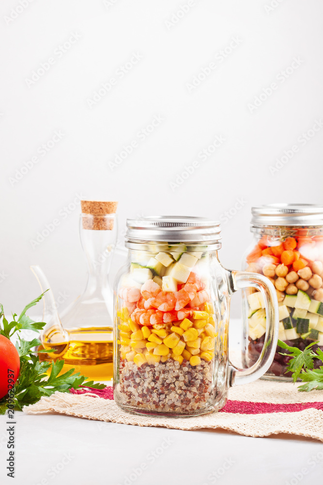 Fresh homemade salad in jars with quinoa, chickpeas and organic vegetables. Healthy take away food, office lunch, vegeterian, detox diet concept. Fresh homemade salad in jars with quinoa, chickpeas and organic vegetables. Healthy take away food, office lunch, vegeterian, detox diet concept.