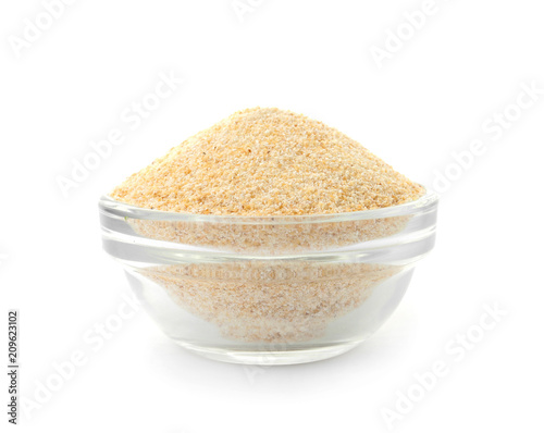 Bowl of dry garlic powder on white background
