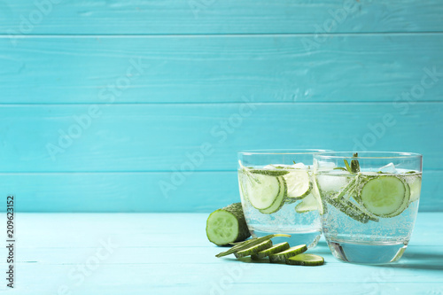 Natural lemonade with cucumber in glasses on wooden table