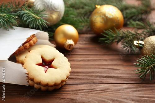 Traditional Christmas Linzer cookies with sweet jam on wooden table