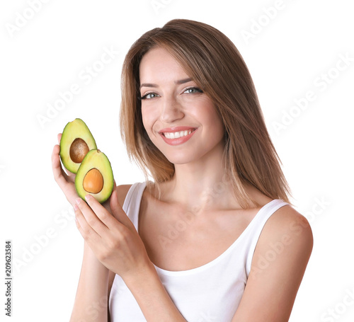 Portrait of young beautiful woman with ripe delicious avocado on white background
