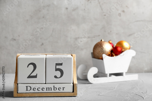 Wooden block calendar and decor on table. Christmas countdown photo