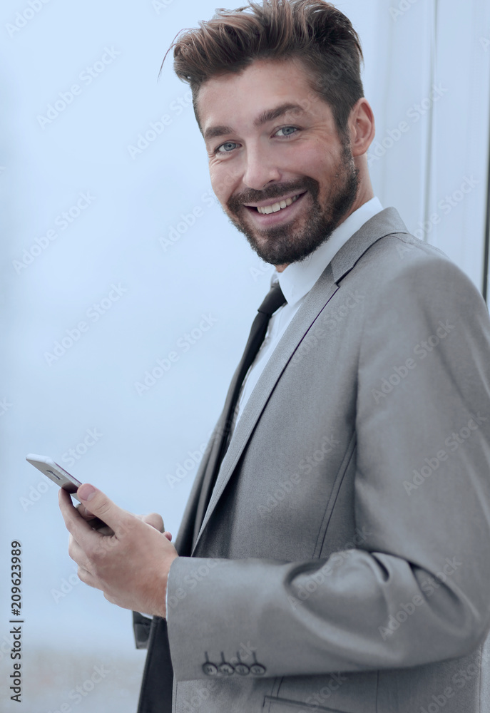 Stylish man in suit is reading information on phone