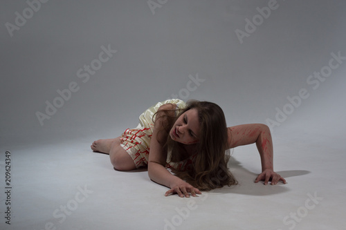 фотографія Girl in a bloody dress screams in pain