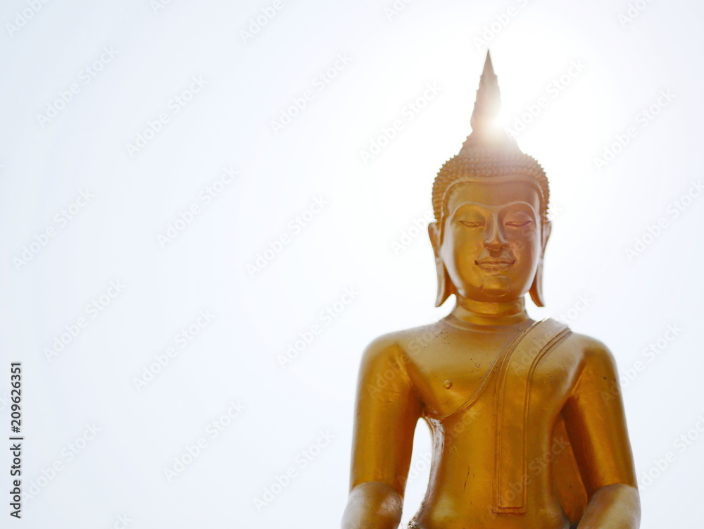 The Lord Buddha image / statue on bright sky and the sun - symbolizes the fact that he has entered the light and been the light for mankind The Lord Buddha image / statue on bright sky and the sun - symbolizes the fact that he has entered the light and been the light for mankind