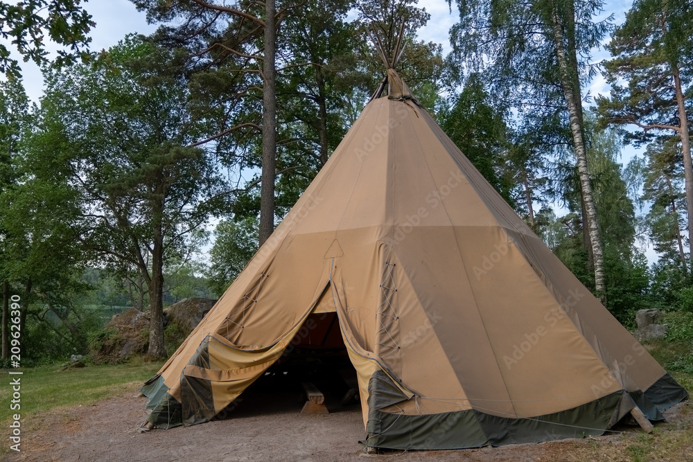 A large traditional teepee tent with luxurious glamping interior provides  alternate but comfortable lodging for adventure seeking, outdoor loving  tourists, or a eco friendly peaceful holiday retreat. Photos | Adobe Stock