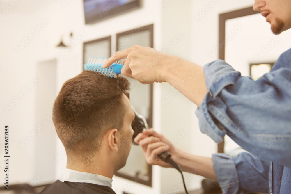 Professional barber working with client in hairdressing salon. Hipster fashion Professional barber working with client in hairdressing salon. Hipster fashion