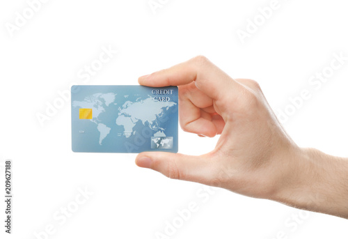 Young man holding credit card on white background