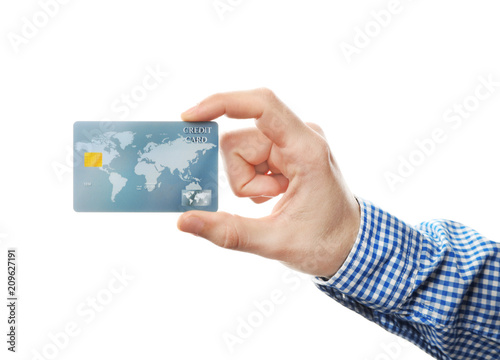 Young man holding credit card on white background