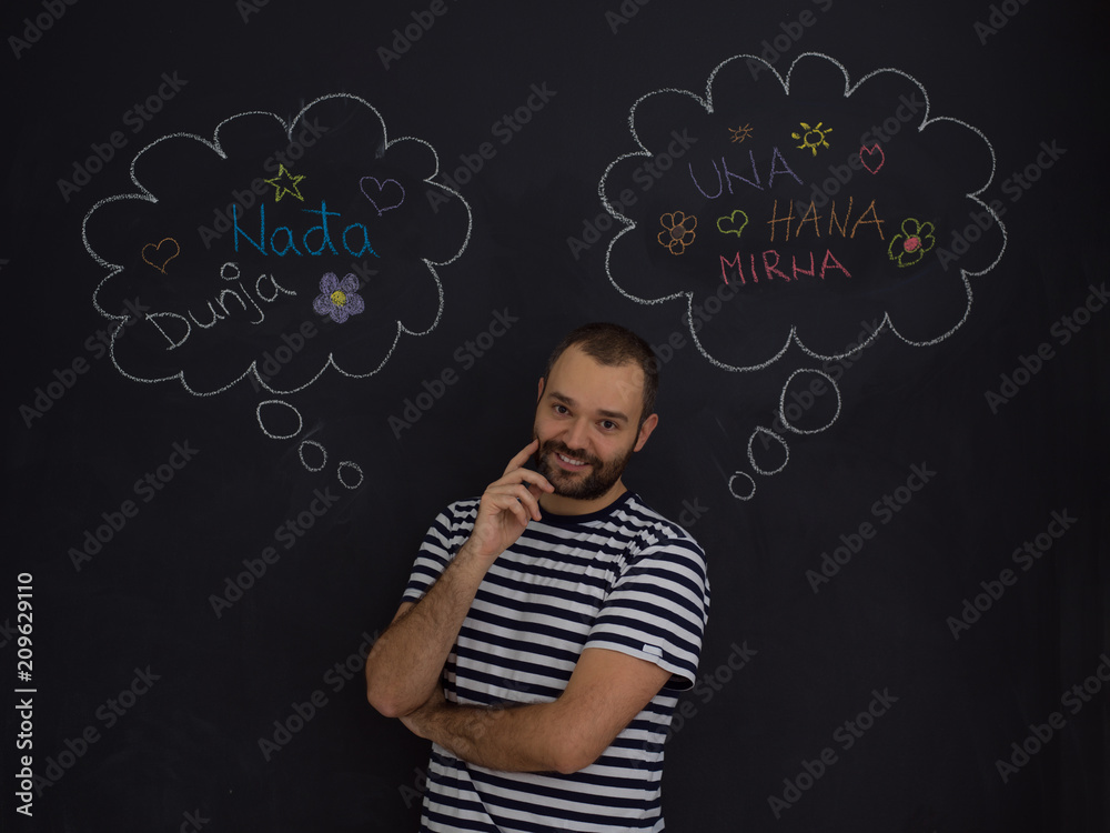 young future father thinking in front of black chalkboard