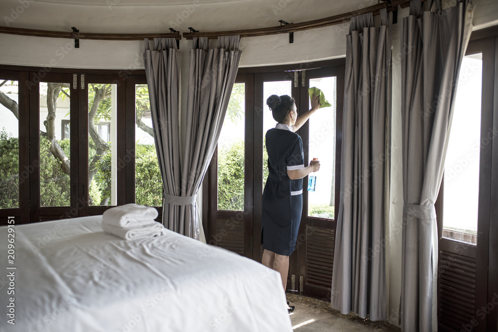 Housekeeper cleaning a hotel window Stock Photo Adobe Stock