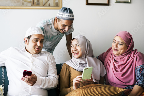 Muslim friends using social media on phones photo