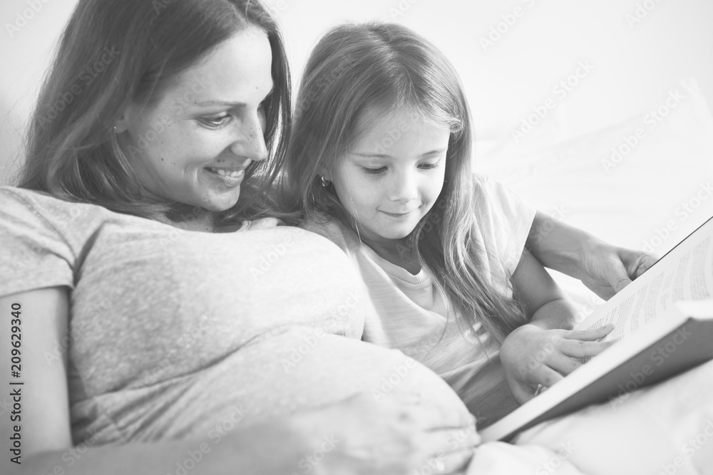 Pregnant mom spending time together with her daughter Pregnant mom spending time together with her daughter