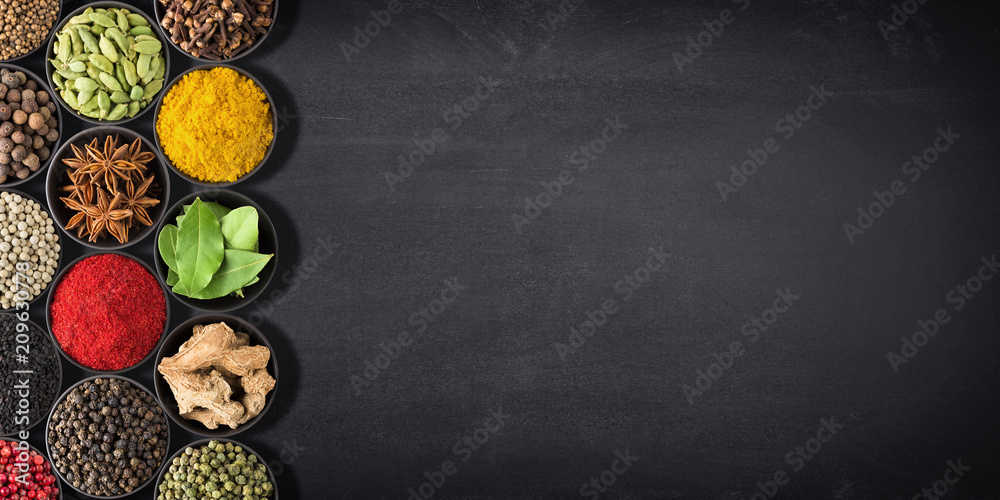 spices and herbs for cooking. seasonings on black table with space for recipe. spices and herbs for cooking. seasonings on black table with space for recipe.