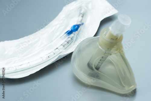 Mask , syringe and endotracheal tube on the table photo