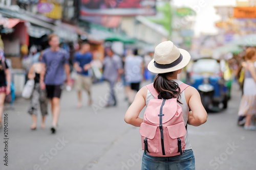 Young Woman traveling with hat, Asian hipster traveler walking at famous backpacker street in Bangkok (Khao San road), landmark and popular for tourist attractions in Thailand. Travel concept © Jo Panuwat D