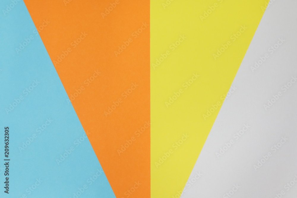 Paper variety. Blue, yellow, orange and white stacked on the floor. background Paper variety. Blue, yellow, orange and white stacked on the floor. background