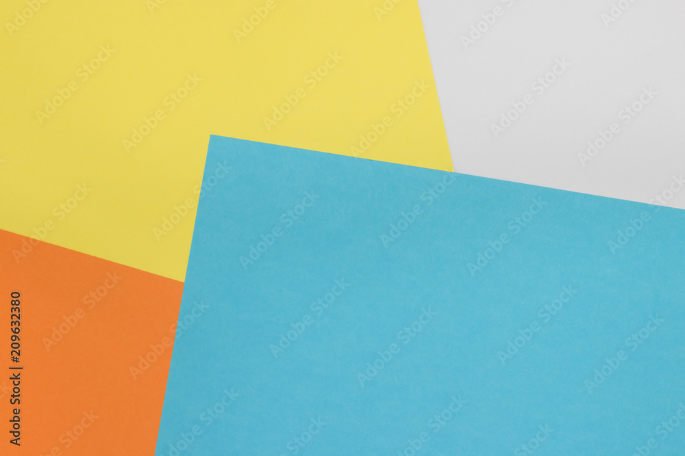 Colorful paper background on top view . (blue, white, yellow, orange)