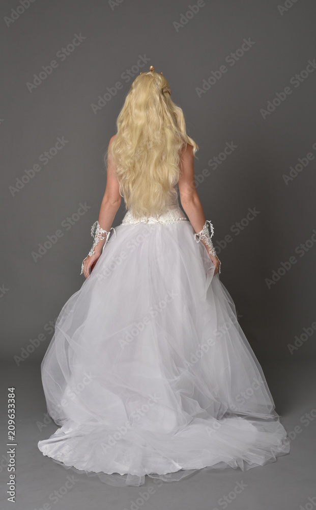 full length portrait of blonde girl wearing white gown, standing pose