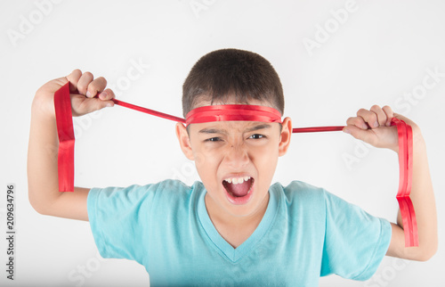 Boy tie a bow on his head intend to cheering up for sport