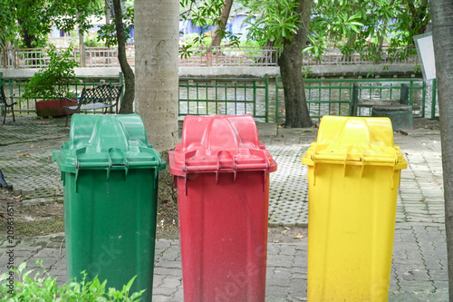 Different Colored Three Garbage Bins in public place, Environmental protection © eakstocker