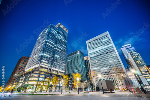 Asia Business concept for real estate and corporate construction - looking up view of panoramic urban city skyline view under twilight sky and neon night in tokyo, Japan © voyata