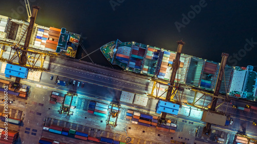 Logistics and transportation of Container Cargo ship and Cargo plane with working crane bridge in shipyard at night, logistic import export and transport industry background