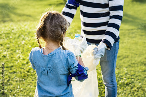 Kids picking up trash in the park