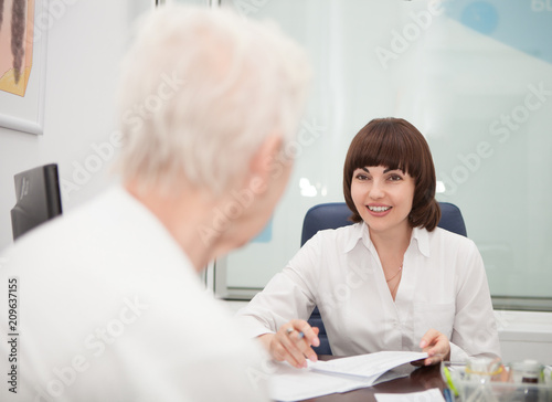 Woman Doctor talking with a patient