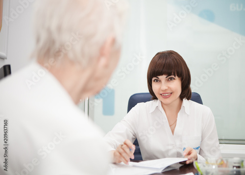 Woman Doctor talking with a patient