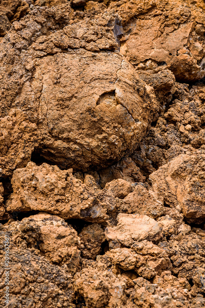 Ancient lava field of orange iron stained rock, with great texture and a round lava rock, Hawaii
Ancient lava field of orange iron stained rock, with great texture and a round lava rock, Hawaii