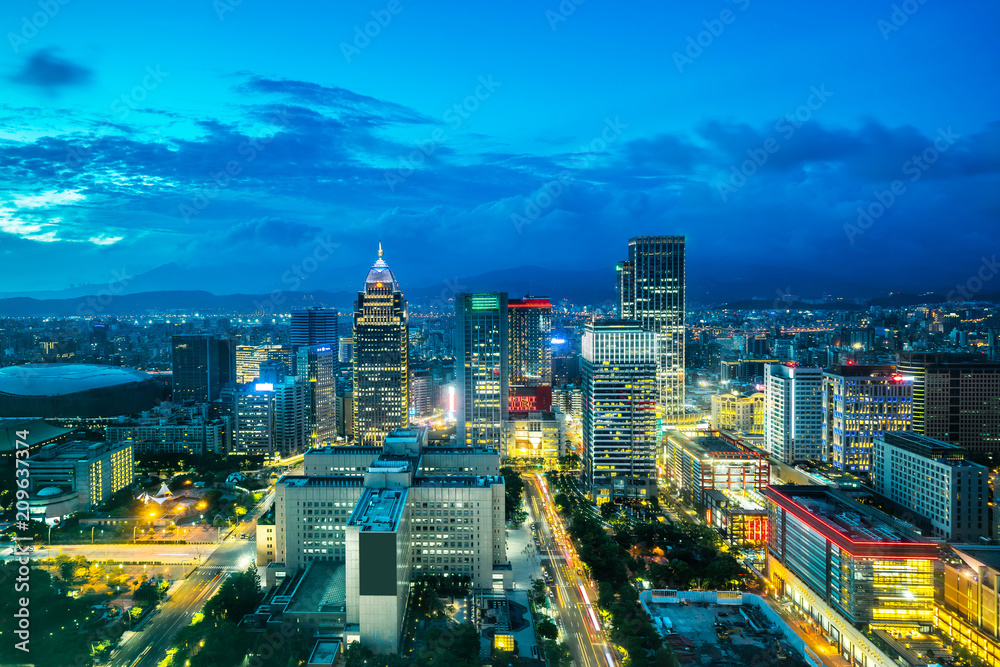 Asia Business concept for real estate and corporate construction - panoramic urban city skyline aerial view and tokyo station under twilight sky and neon night in Taipei, Taiwan