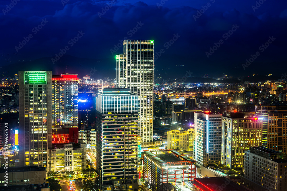 Fototapeta premium Asia Business concept for real estate and corporate construction - panoramic urban city skyline aerial view and tokyo station under twilight sky and neon night in Taipei, Taiwan