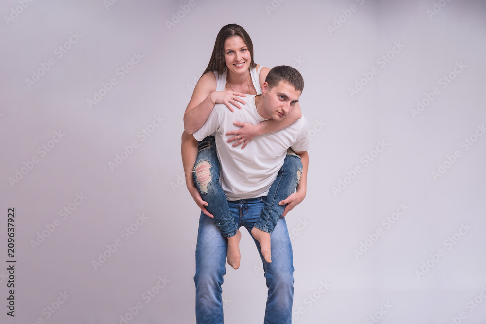 Portrait of beautiful brunette girl and young guy on white background in family happiness Portrait of beautiful brunette girl and young guy on white background in family happiness