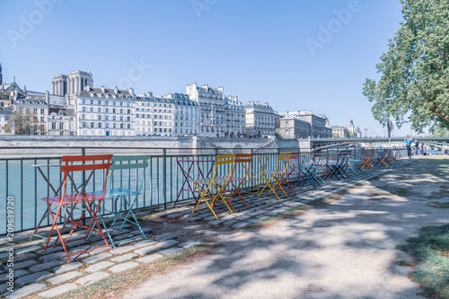 Empty outdoor cafe on the banks of the Seine. © tbralnina