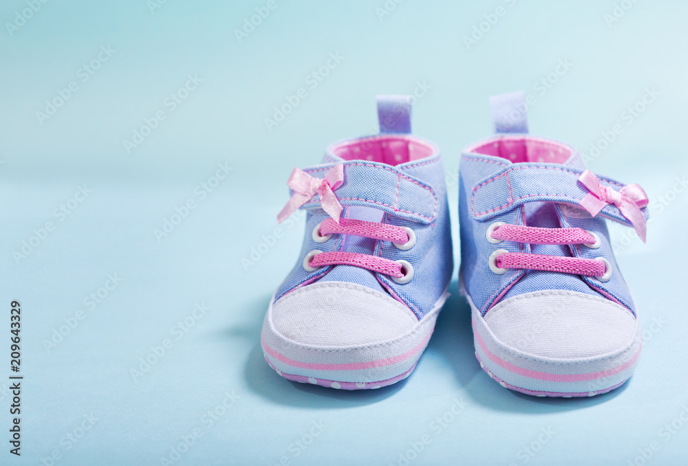 baby sneakers on blue background