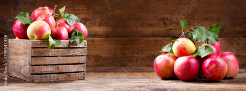 fresh red apples in a wooden box