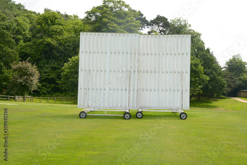 Cricket sightscreen - wooden and painted white on wheels at Ampthill Town Cricket Club in Ampthill, Bedfordshire, England photo