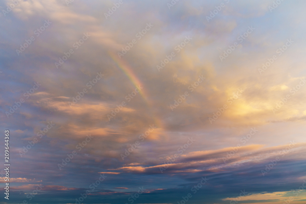 sky with clouds and a rainbow