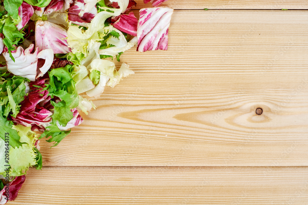 Frame of fresh green salad on wooden background. Healthy natural food . mockup for recipe or menu. Frame of fresh green salad on wooden background. Healthy natural food . mockup for recipe or menu.