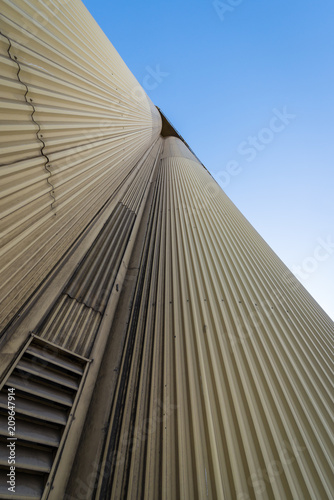 Industrial grain silos against a blue sky