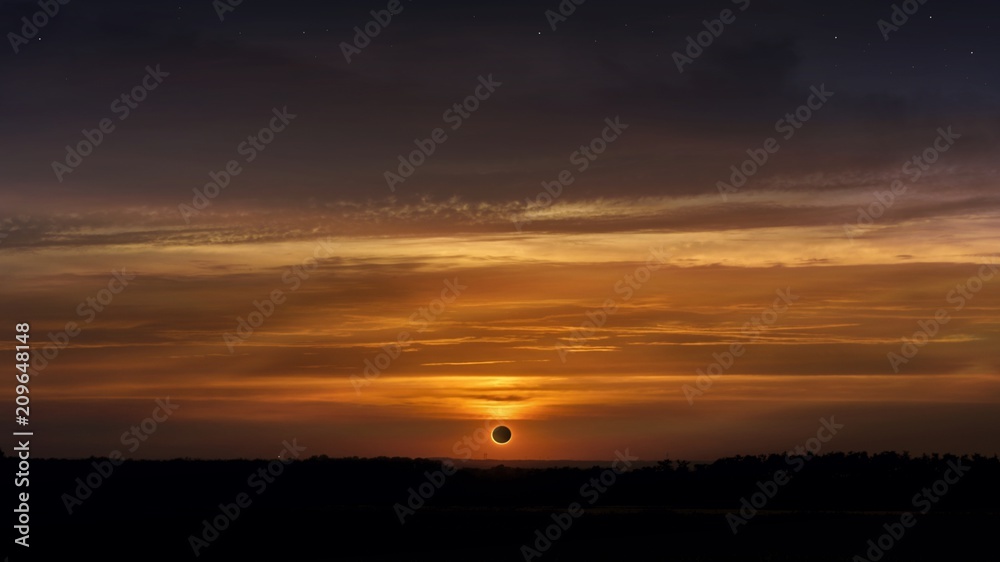 Solar Eclipse . Scientific natural phenomenon . Total solar eclipse with diamond ring effect glowing on sky . Serenity nature background . 