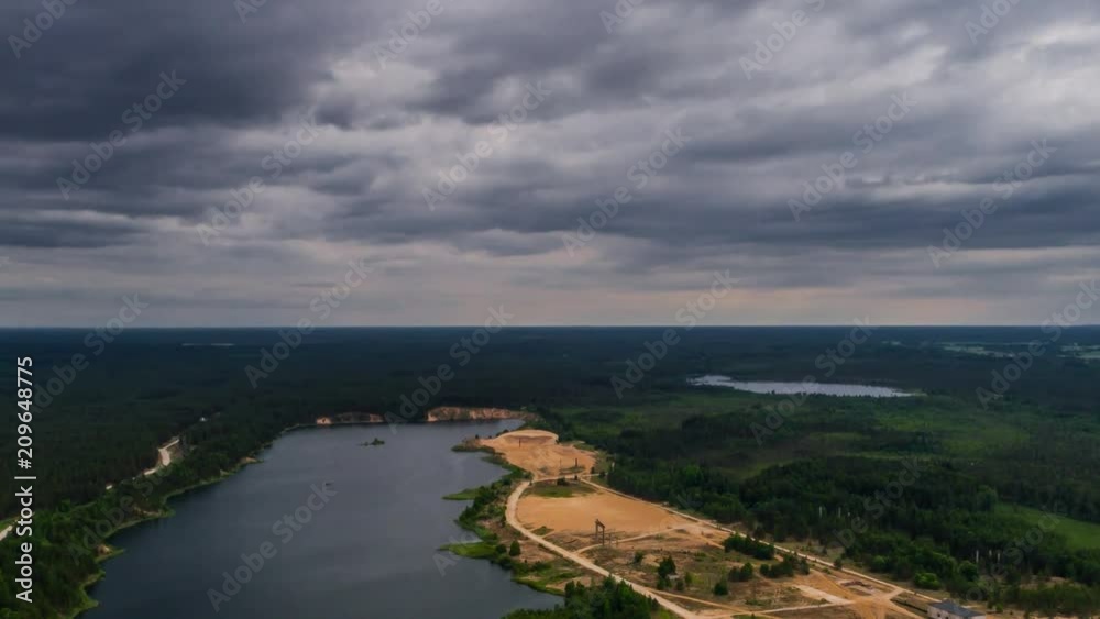 Aerial view of lake and massive clouds above. Drone timelapse footage. Summer nature landscape. Aerial view of lake and massive clouds above. Drone timelapse footage. Summer nature landscape.
