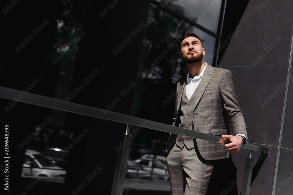 Businessman in city. Modern businessman. Confident young man in full suit standing outdoors
