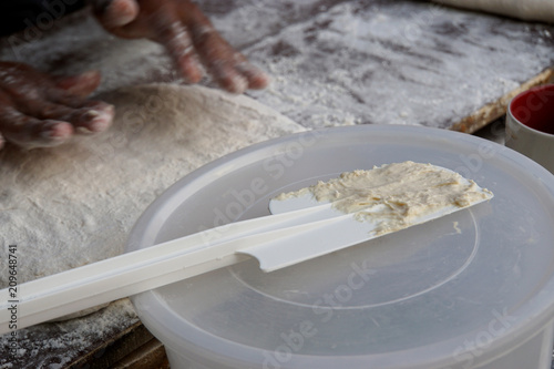 Plastic spatula used for make deep fried dough with hand's man prepare dough background.