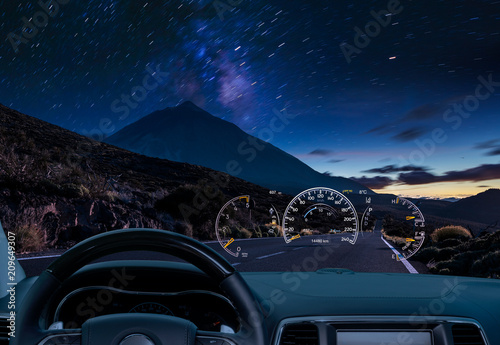 car equipped with a HUD display driving at night along a mountain road .The concept of a modern car