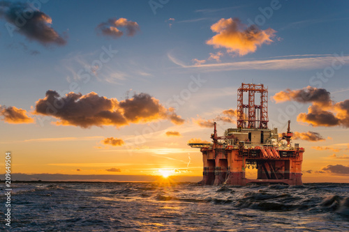 offshore oil rig at sunset photo