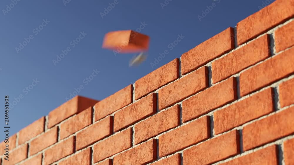 The clay brick wall being build at clear blue sky background. Loopable